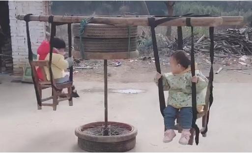 爷爷陪着孙子坐旋转木马,爸爸用铁锨做旋转木马哄孩子