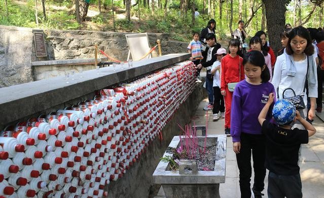 *世友许**将军去世后被特批土葬，范曾题写墓碑，墓前茅台酒瓶堆成墙